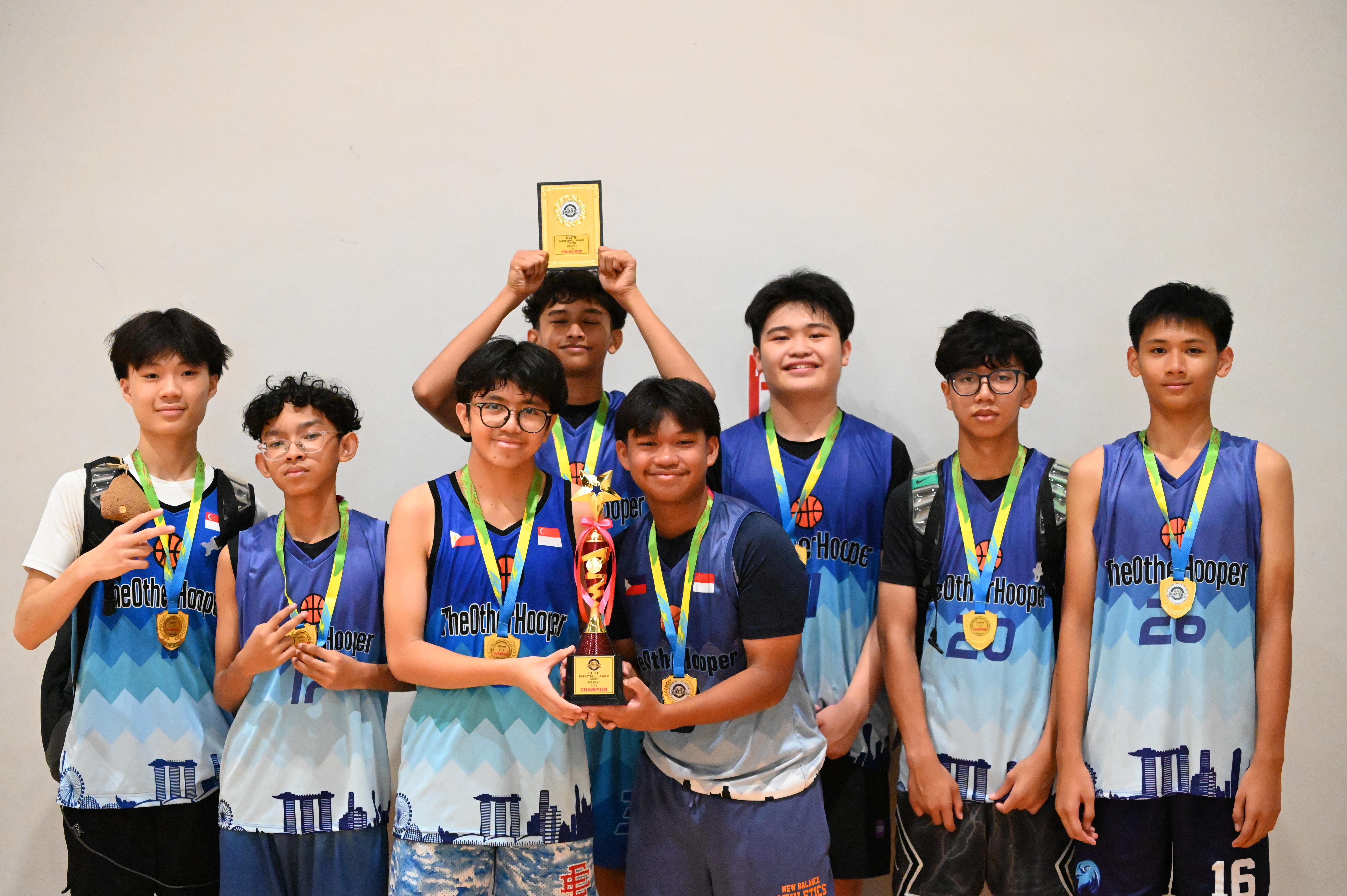TOH youth team celebrating together with medals and a trophy